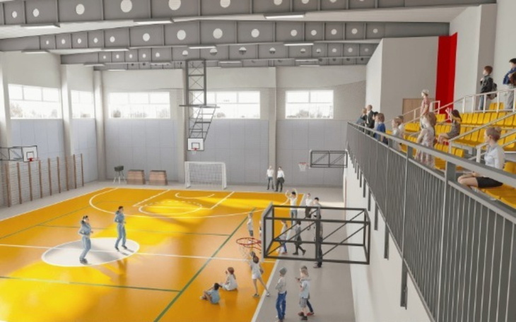 Wnętrze nowoczesnej hali sportowej z widownią.