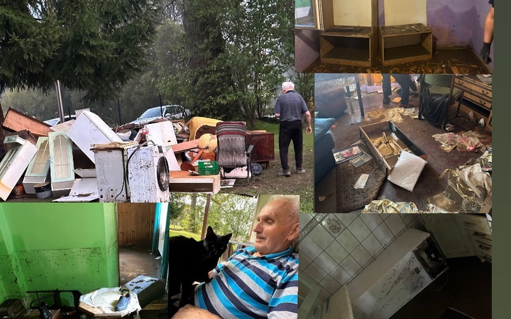 Zniszczone wnętrze domu, z bałaganem i osobą w tle.