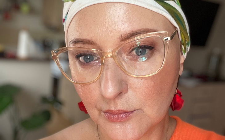 Kobieta w okularach z uśmiechem na twarzy.