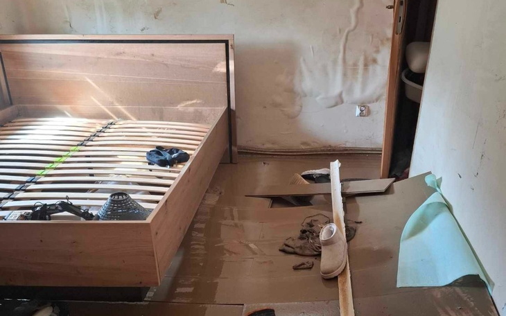 Zniszczony pokój z meblami i bałaganem.