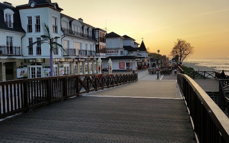 Widok na promenadę nadmorską o zachodzie słońca.