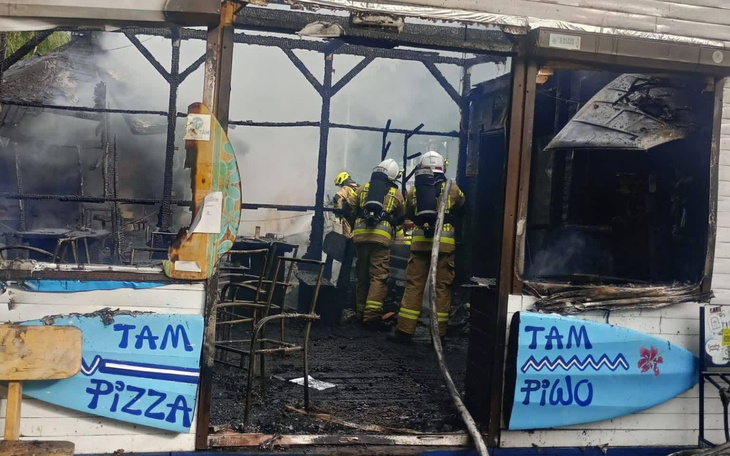 Zniszczony lokal po pożarze, strażacy w akcji.