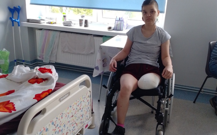 Młoda dziewczyna na wózku inwalidzkim, siedząca w szpitalu.