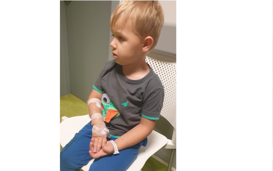 
        Chłopiec w szpitalu z opatrunkiem na ręce.
    