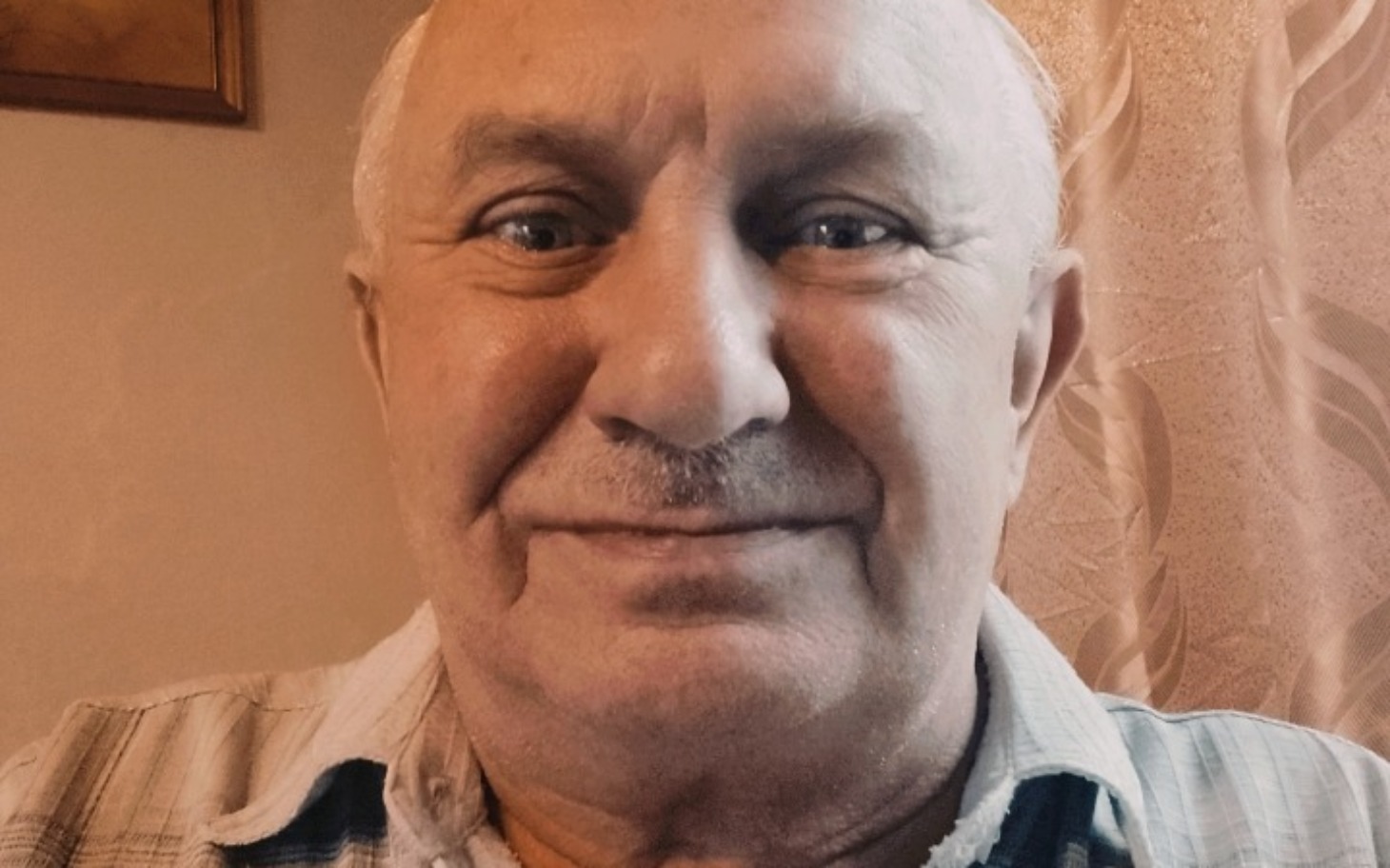 
        Mężczyzna w średnim wieku, uśmiechający się do kamery.
    