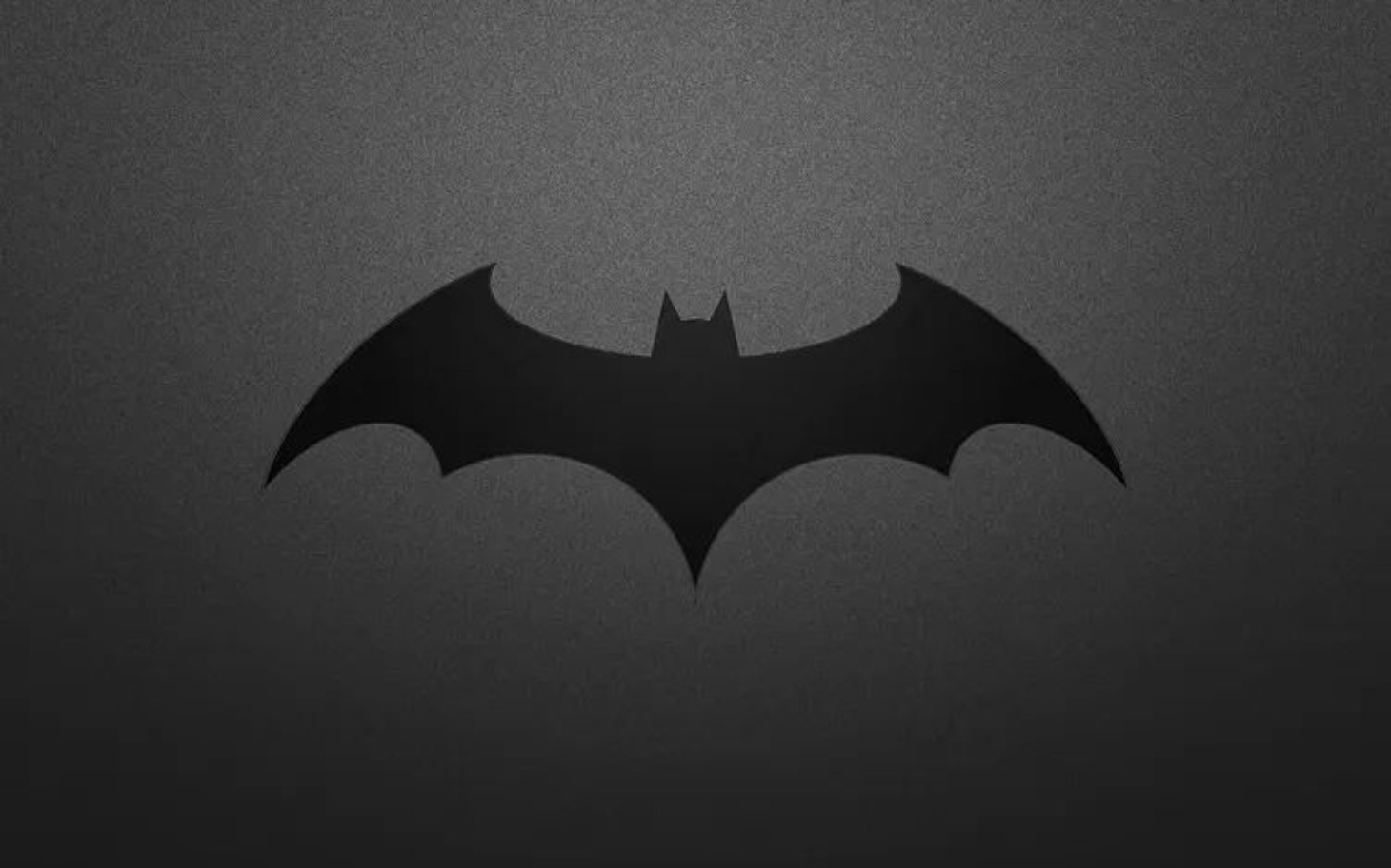 
        Symbol Batmana na ciemnym tle.
    