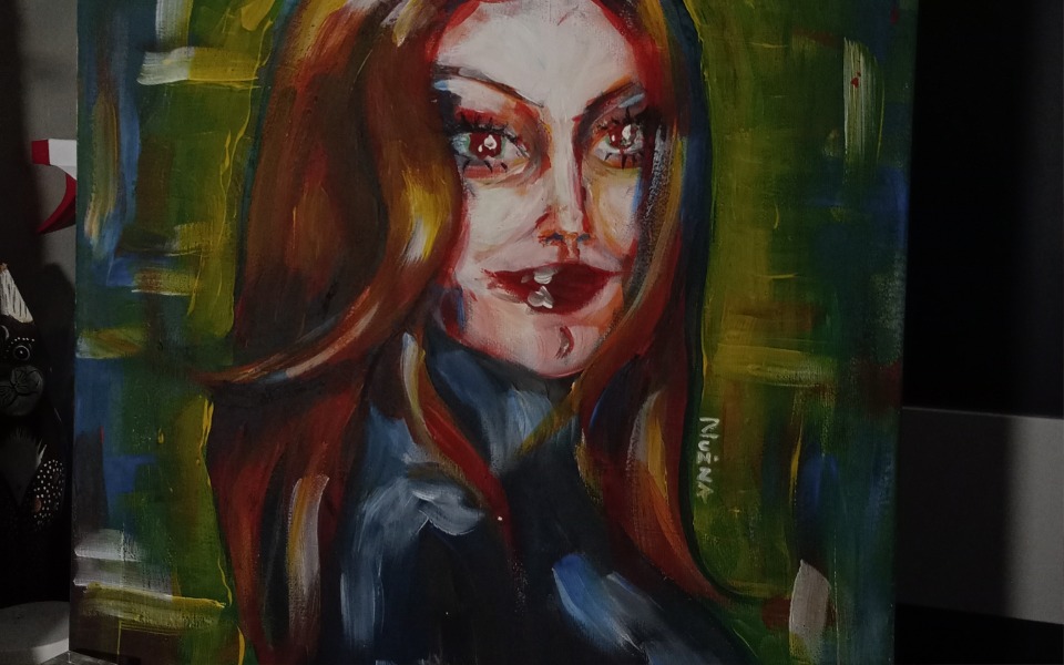 
        Obraz przedstawiający portret kobiety w intensywnych kolorach.
    