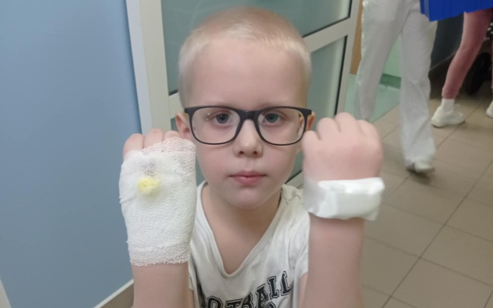 
        Chłopiec z opatrunkami na rękach w szpitalu.
    