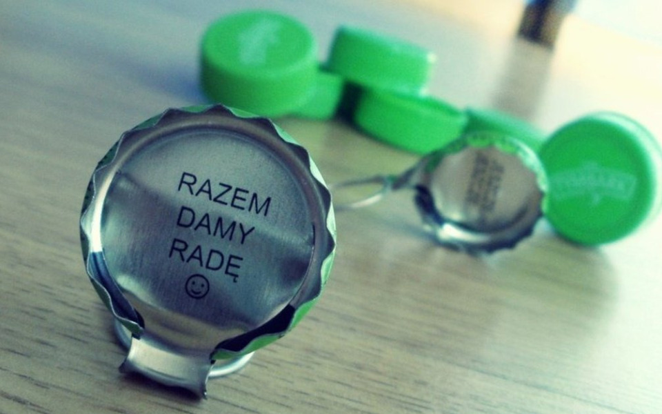 
        Zakrętka od butelki z napisem 'Razem damy radę'.
    