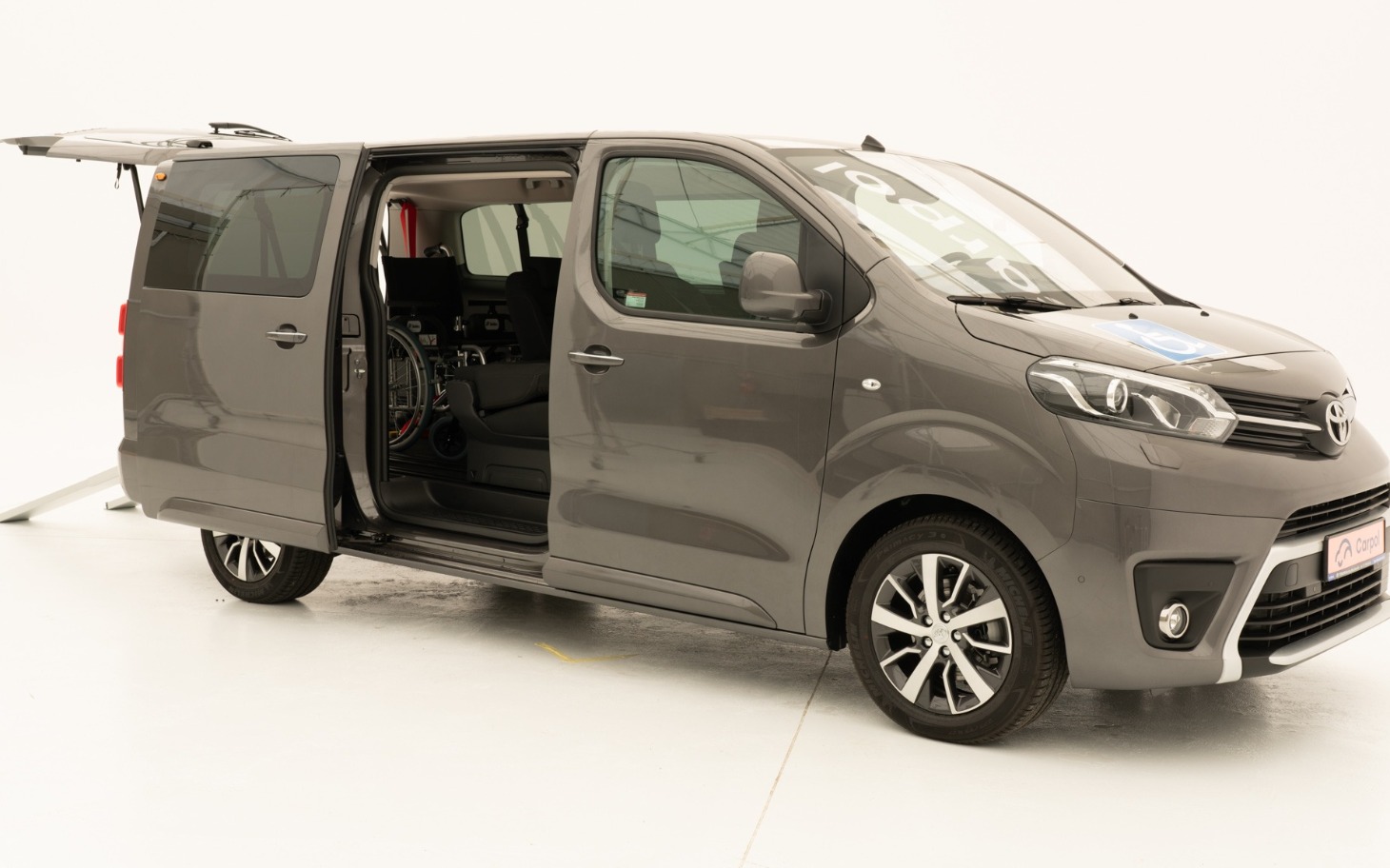 
        Nowoczesny samochód dostawczy w szarym kolorze, otwarte drzwi.
    