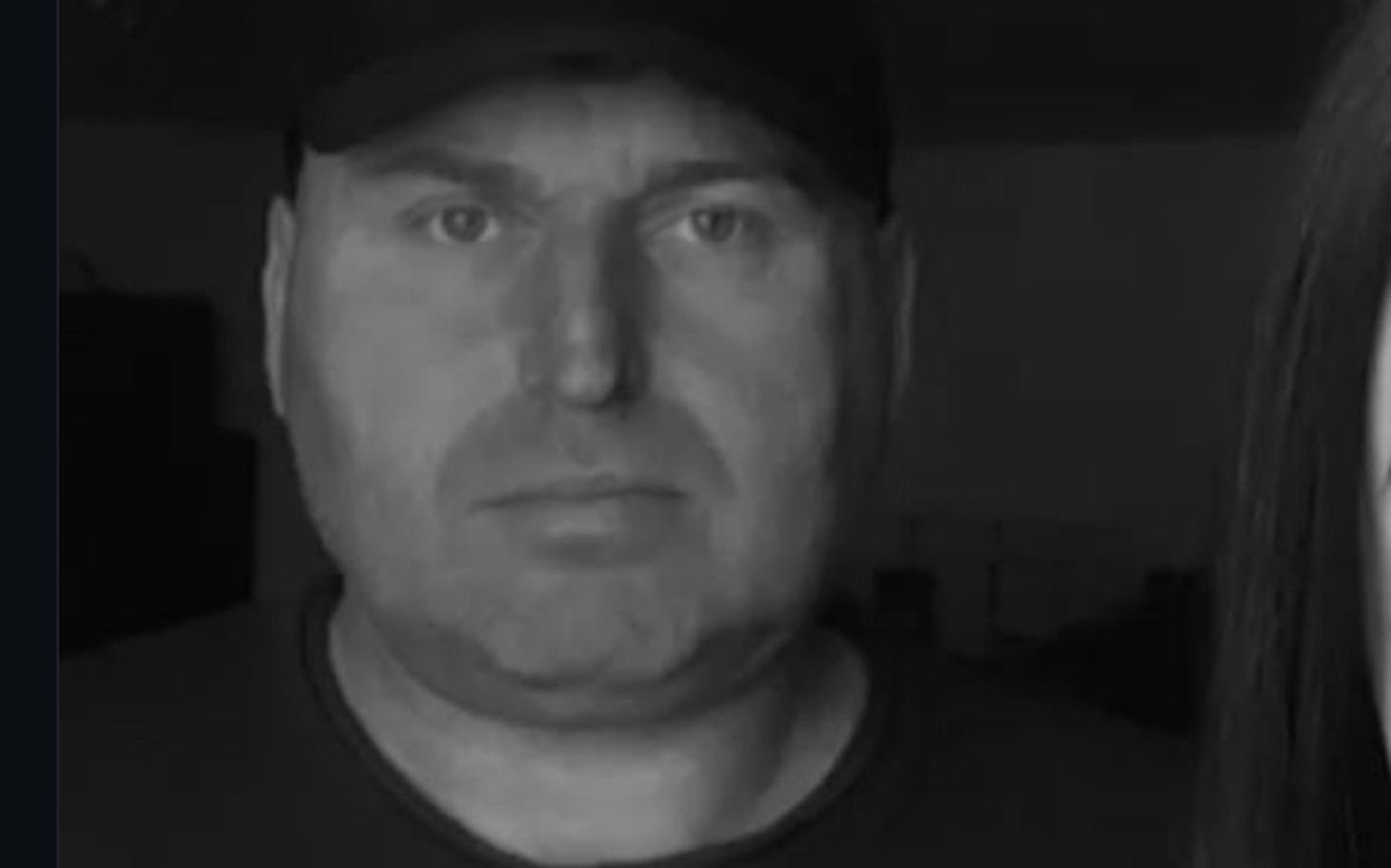 
        Mężczyzna w czapce, poważny wyraz twarzy.
    