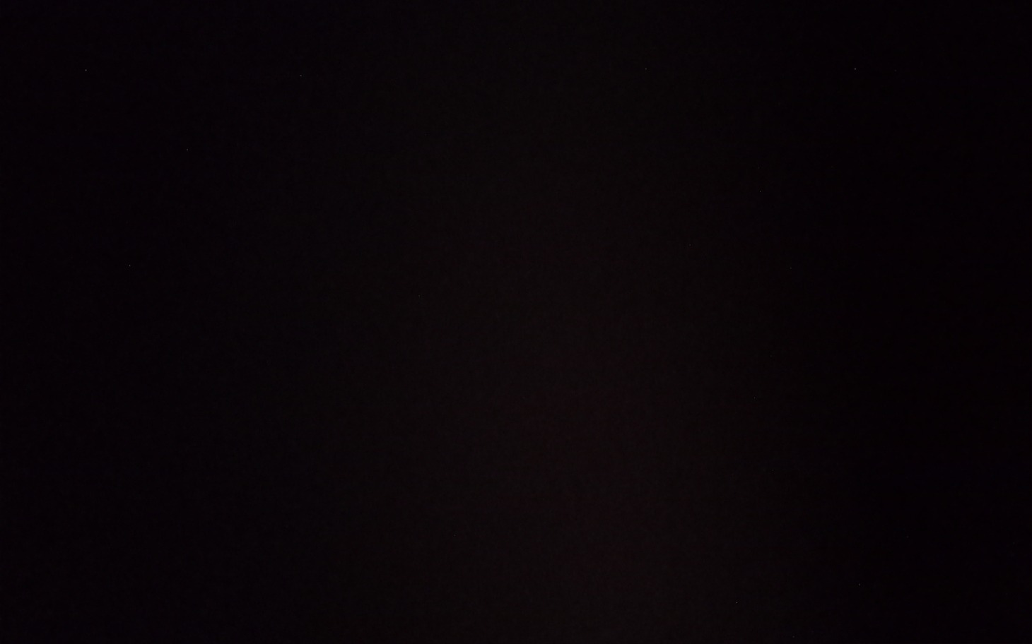 
        Ciemny obraz, prawdopodobnie przedstawiający nocne niebo.
    