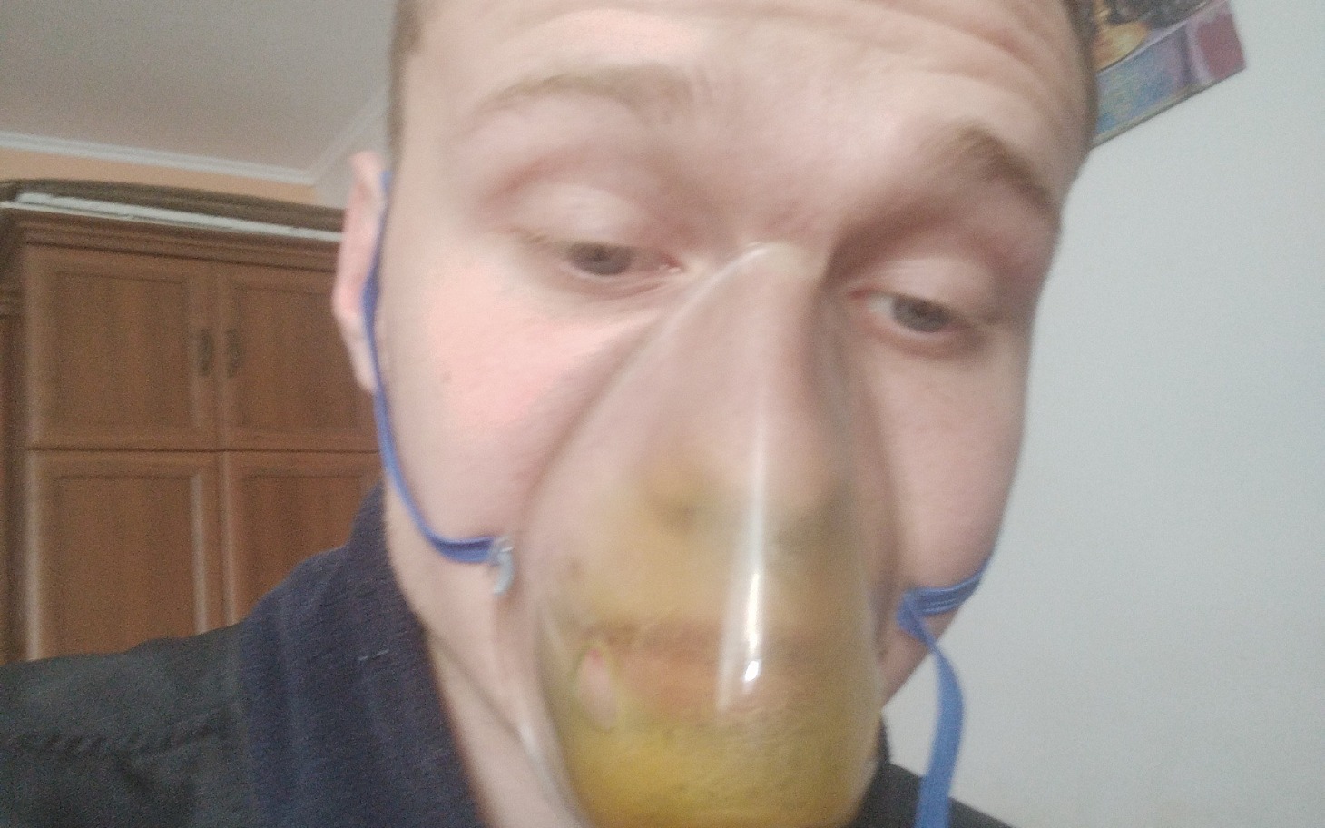 
        Mężczyzna z maską tlenową, patrzący w kamerę.
    
