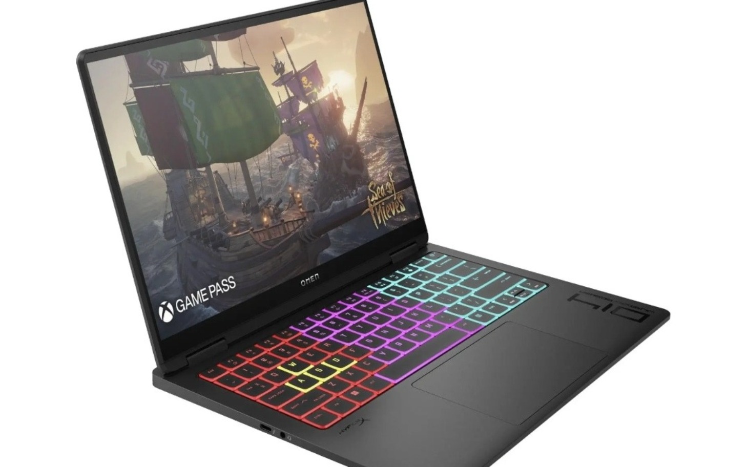 
        Laptop z kolorową klawiaturą, gra na ekranie.
    