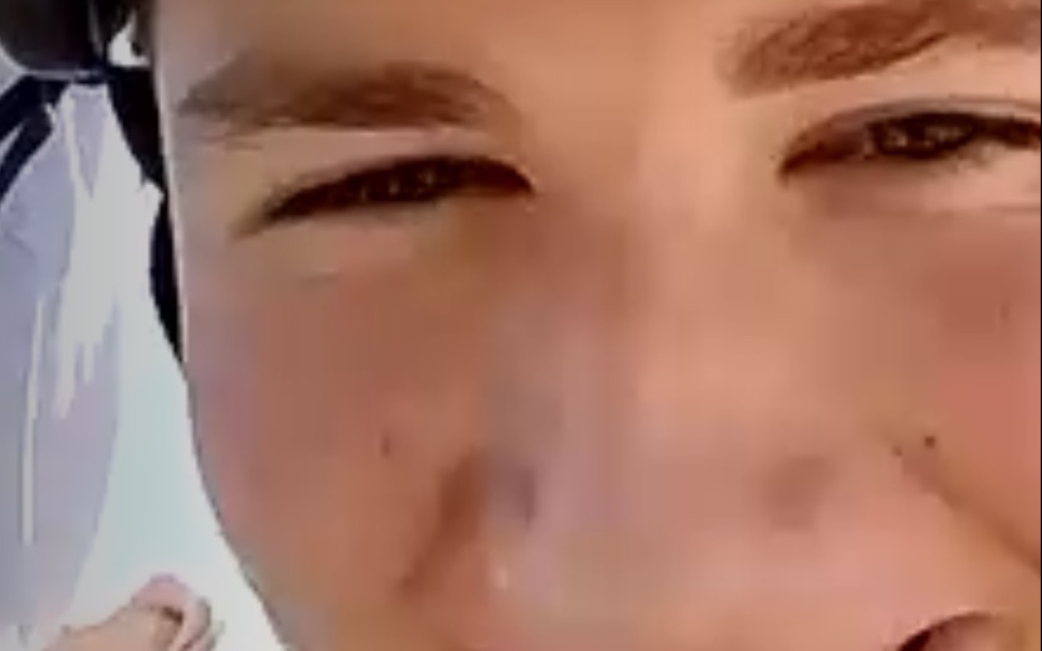 
        Zbliżenie na twarz młodego mężczyzny z uśmiechem.
    