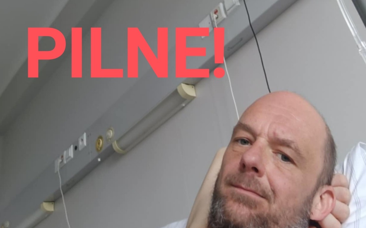 
        Mężczyzna w szpitalu z napisem 'PILNE!' na tle.
    