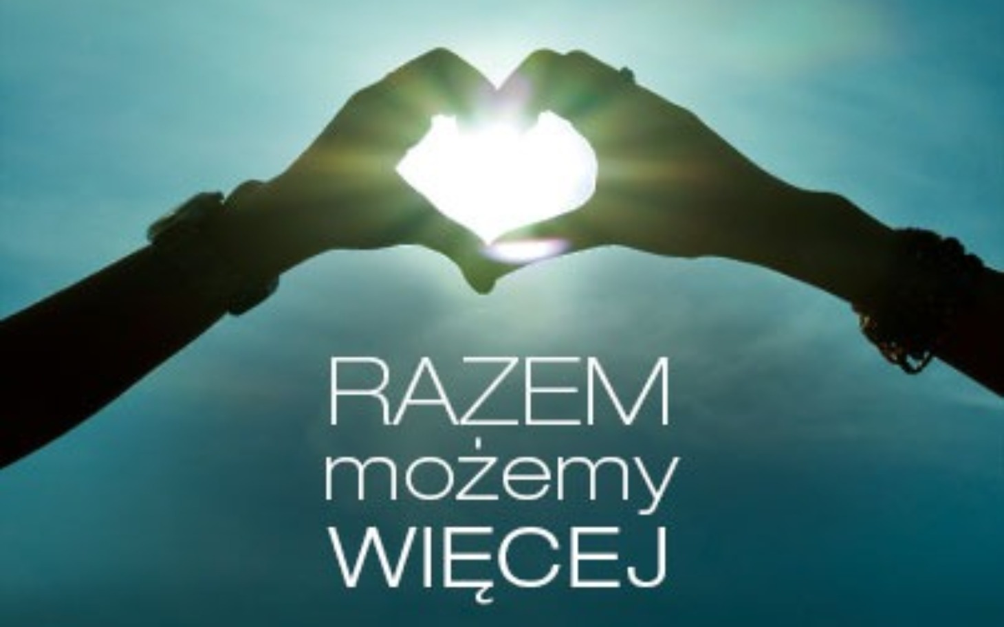 
        Dwie ręce tworzące serce z promieniami słońca.
    