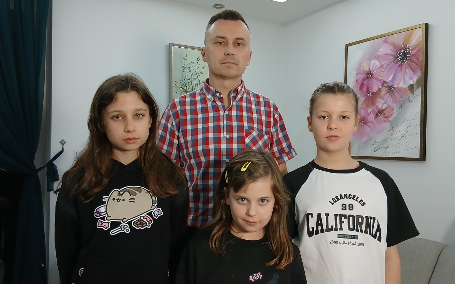 
        Rodzina pozująca do zdjęcia w jasnym wnętrzu.
    