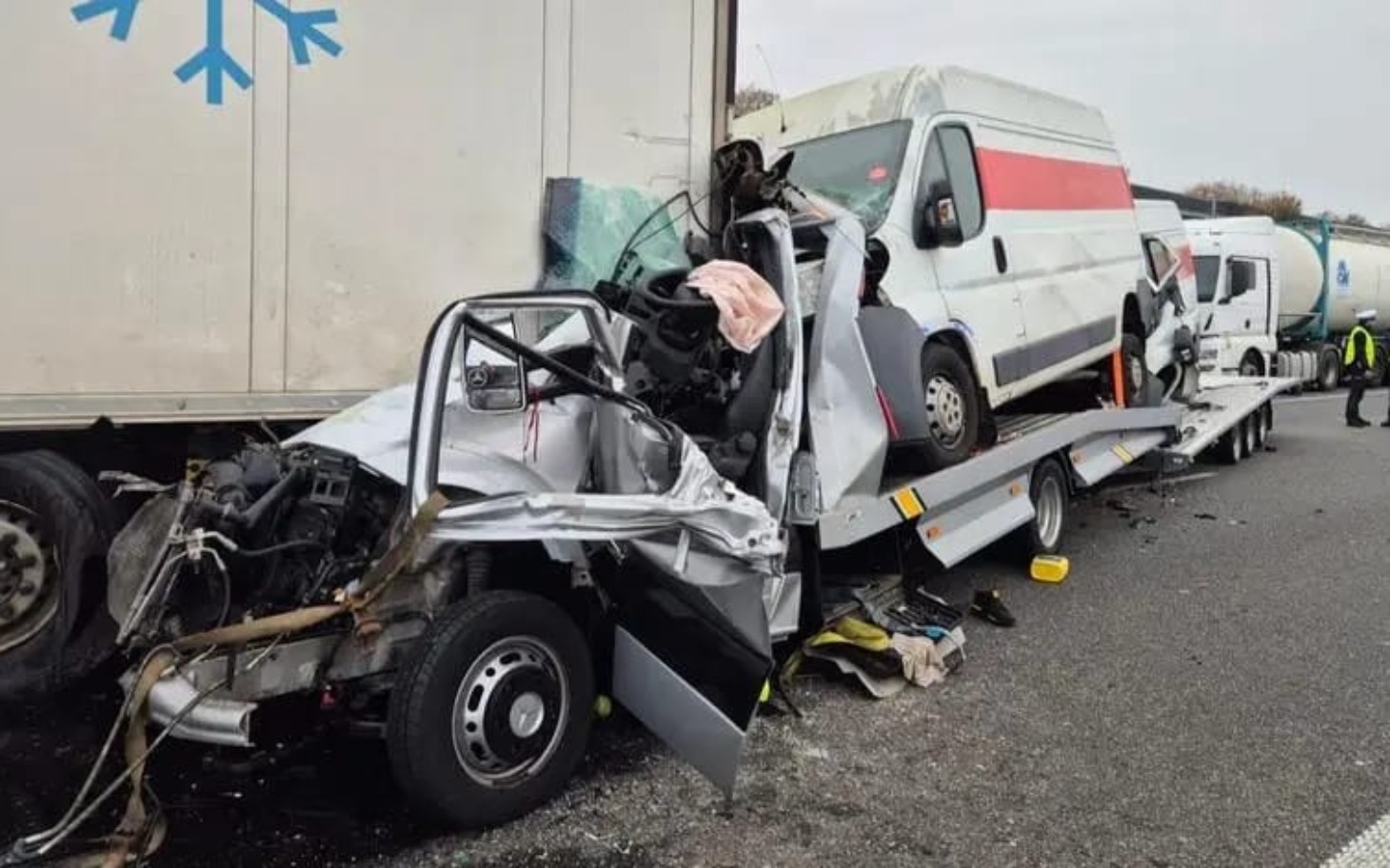 
        Wypadek drogowy z uszkodzonymi pojazdami na drodze.
    