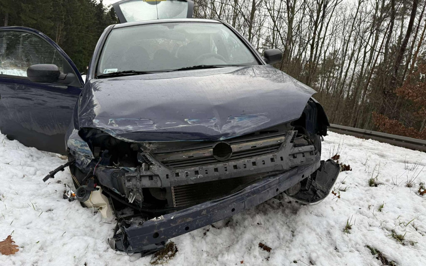 
        Zniszczony samochód po wypadku w lesie.
    