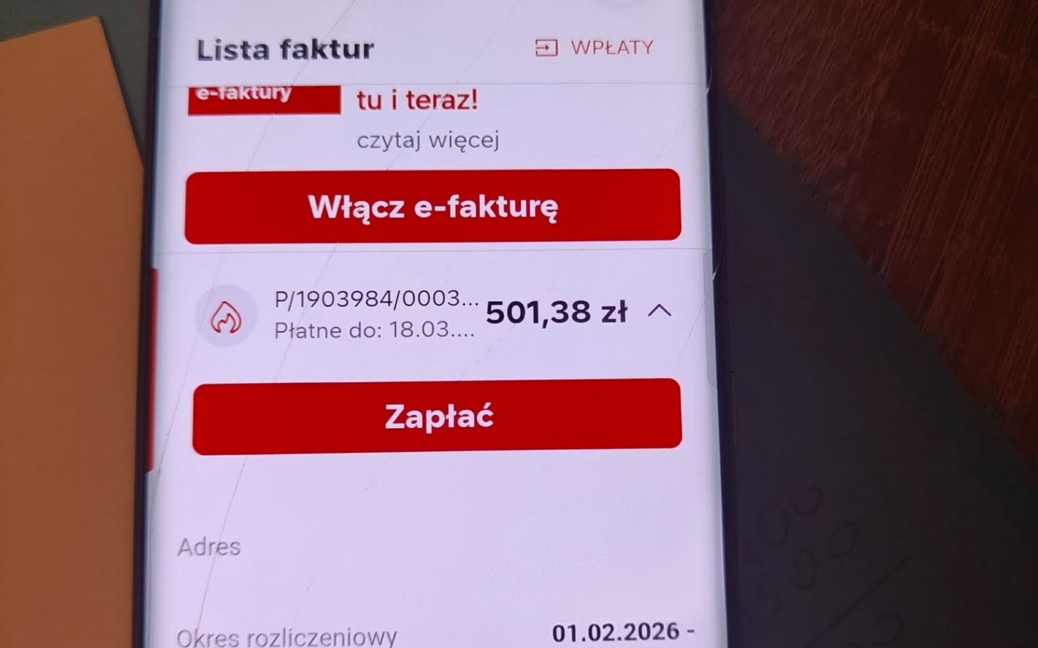 
        Ekran telefonu z informacjami o e-fakturze.
    