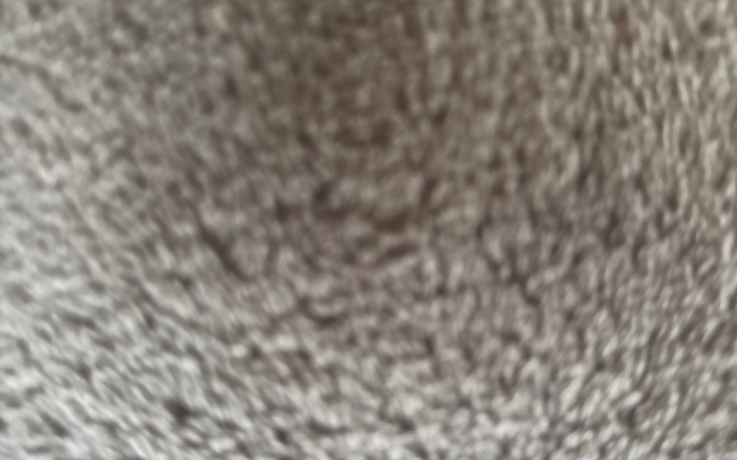 
        Rozmyty obraz, prawdopodobnie przedstawiający teksturę lub materiał.
    